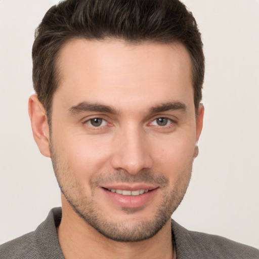 Joyful white young-adult male with short  brown hair and brown eyes