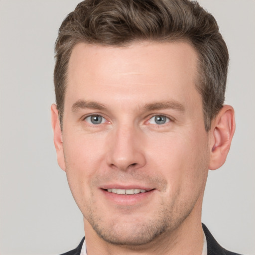 Joyful white adult male with short  brown hair and grey eyes