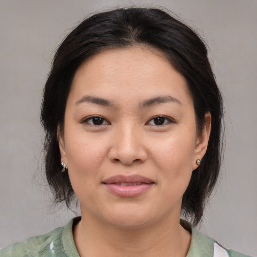 Joyful asian young-adult female with medium  brown hair and brown eyes
