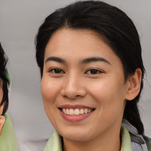 Joyful asian young-adult female with medium  brown hair and brown eyes