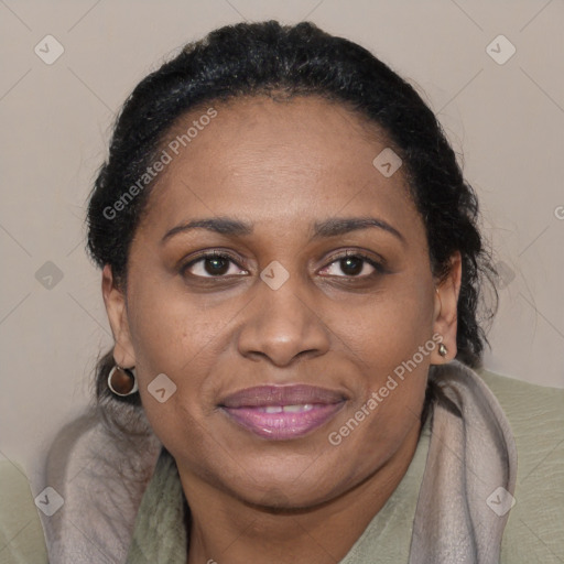 Joyful black adult female with medium  brown hair and brown eyes