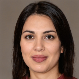 Joyful white adult female with long  brown hair and brown eyes