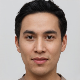 Joyful asian young-adult male with short  black hair and brown eyes