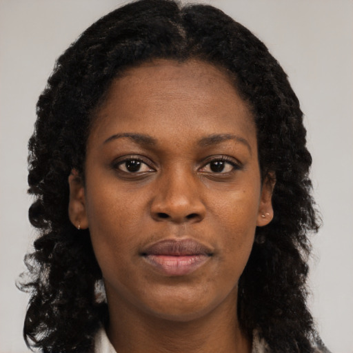 Neutral black young-adult female with long  brown hair and brown eyes