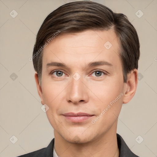 Joyful white young-adult male with short  brown hair and grey eyes