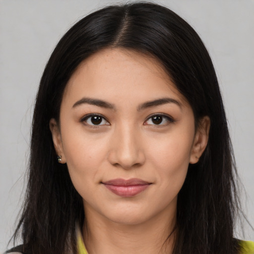 Joyful latino young-adult female with long  brown hair and brown eyes