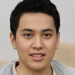 Joyful latino young-adult male with short  brown hair and brown eyes