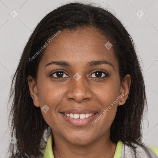 Joyful black young-adult female with long  brown hair and brown eyes