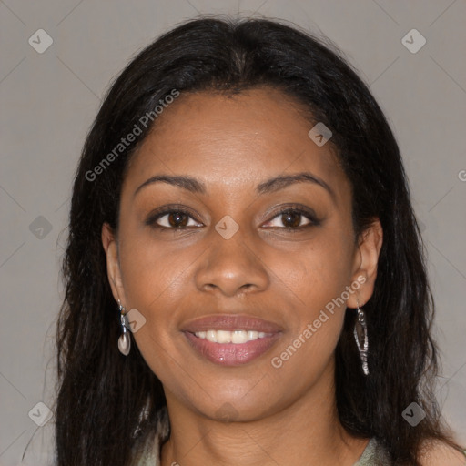 Joyful black young-adult female with long  brown hair and brown eyes