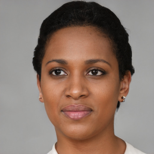 Joyful black young-adult female with short  black hair and brown eyes