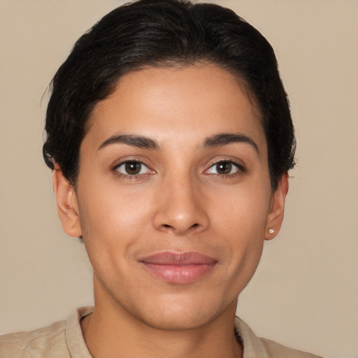 Joyful latino young-adult female with short  brown hair and brown eyes