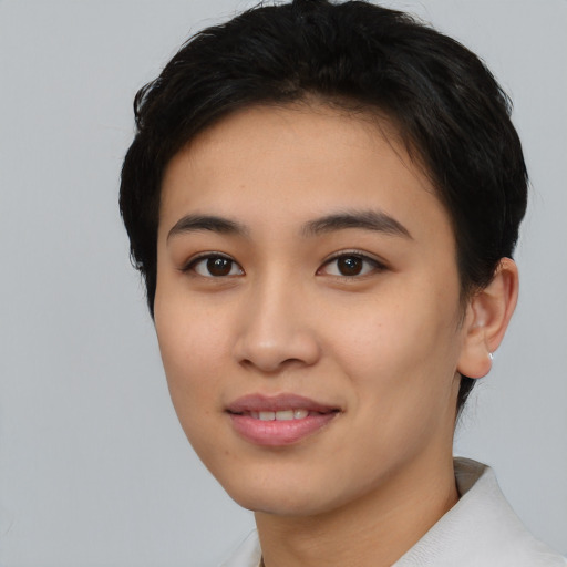 Joyful asian young-adult female with short  black hair and brown eyes