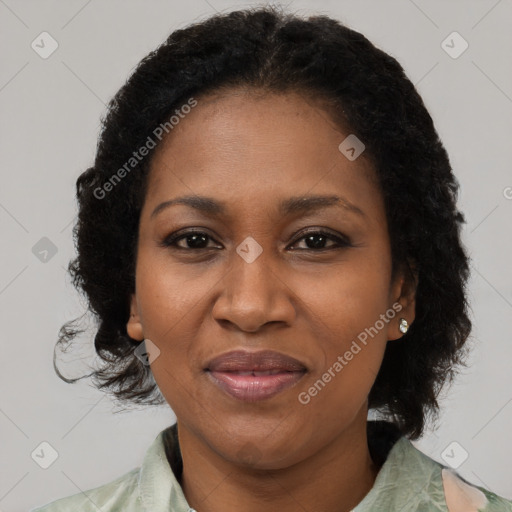 Joyful black adult female with medium  brown hair and brown eyes