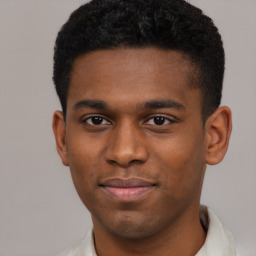 Joyful black young-adult male with short  brown hair and brown eyes