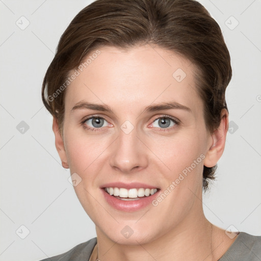 Joyful white young-adult female with short  brown hair and grey eyes