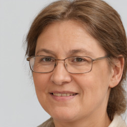 Joyful white adult female with medium  brown hair and brown eyes