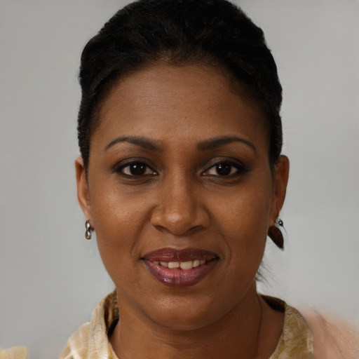 Joyful black young-adult female with short  brown hair and brown eyes