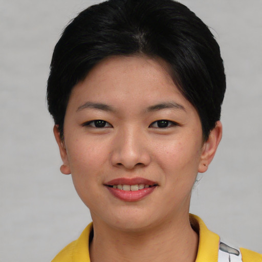 Joyful asian young-adult female with short  black hair and brown eyes