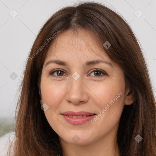 Joyful white adult female with long  brown hair and brown eyes