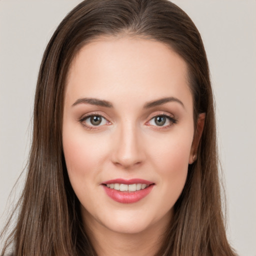 Joyful white young-adult female with long  brown hair and brown eyes