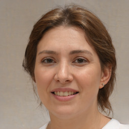 Joyful white adult female with medium  brown hair and brown eyes