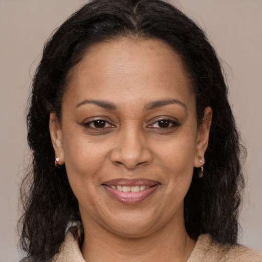 Joyful latino adult female with long  brown hair and brown eyes