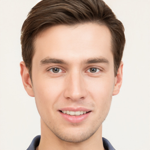 Joyful white young-adult male with short  brown hair and grey eyes