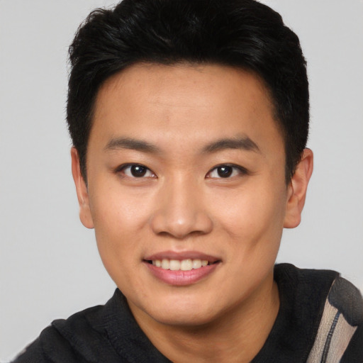 Joyful asian young-adult male with short  black hair and brown eyes