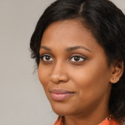 Joyful black young-adult female with long  brown hair and brown eyes