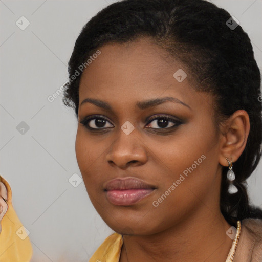 Joyful black young-adult female with long  brown hair and brown eyes