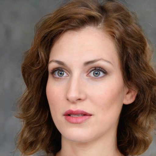 Joyful white young-adult female with medium  brown hair and blue eyes