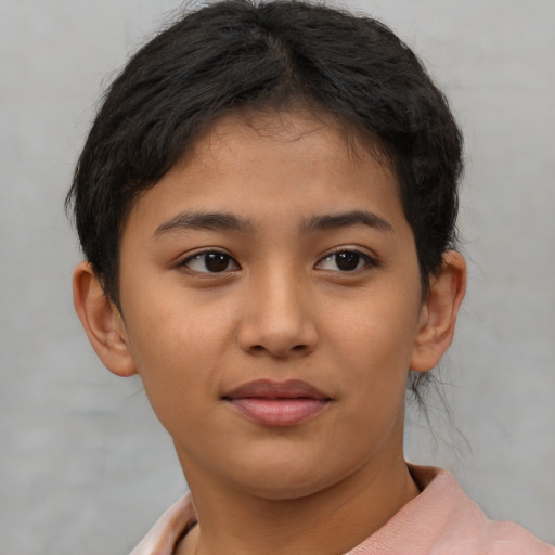 Joyful asian child female with short  brown hair and brown eyes