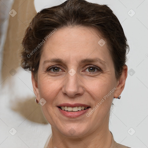 Joyful white adult female with short  brown hair and grey eyes