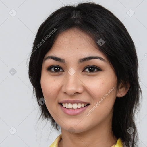 Joyful asian young-adult female with long  brown hair and brown eyes