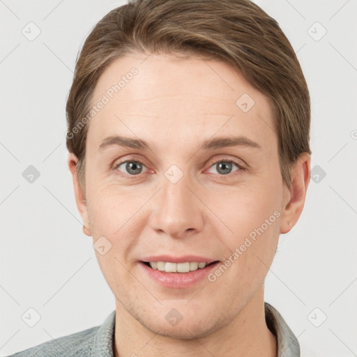 Joyful white young-adult female with short  brown hair and grey eyes