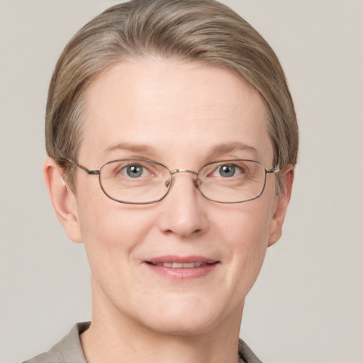 Joyful white adult female with short  brown hair and grey eyes