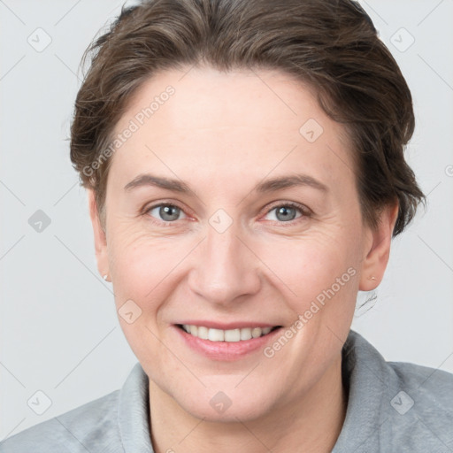 Joyful white adult female with short  brown hair and grey eyes