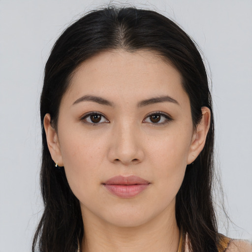 Joyful asian young-adult female with long  brown hair and brown eyes