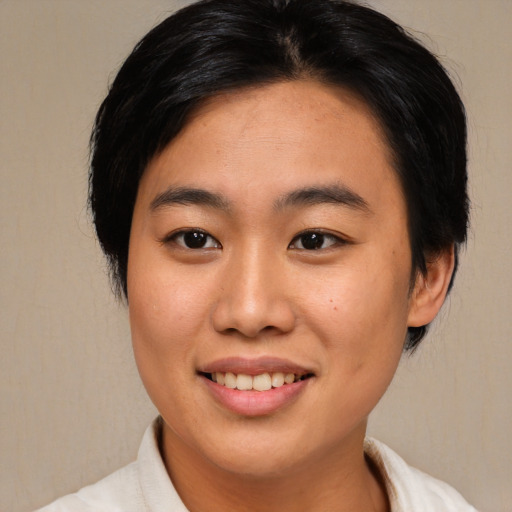 Joyful asian young-adult female with medium  black hair and brown eyes