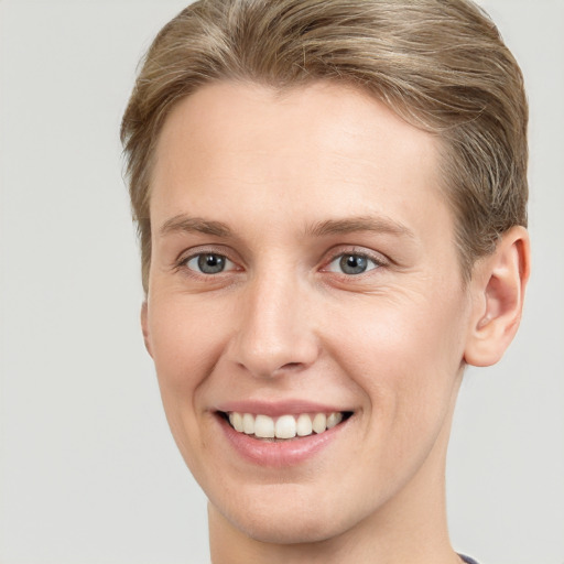 Joyful white young-adult female with short  brown hair and grey eyes