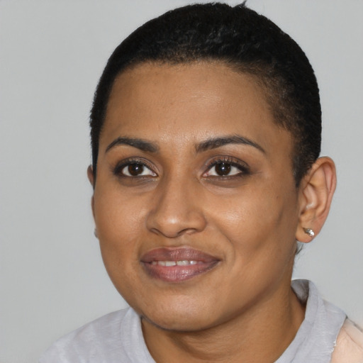 Joyful black young-adult female with short  black hair and brown eyes