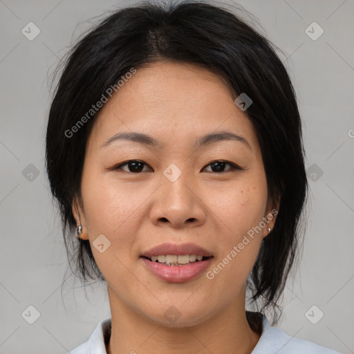 Joyful asian adult female with medium  brown hair and brown eyes