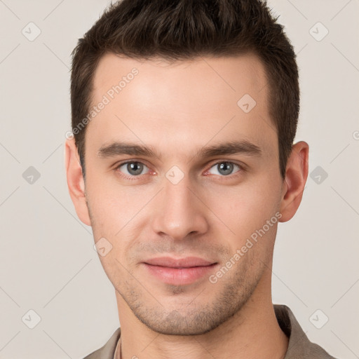 Joyful white young-adult male with short  brown hair and grey eyes