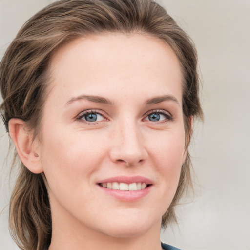 Joyful white young-adult female with medium  brown hair and blue eyes