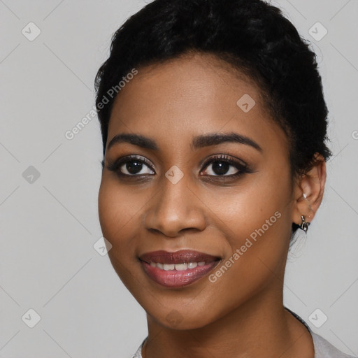 Joyful black young-adult female with short  black hair and brown eyes