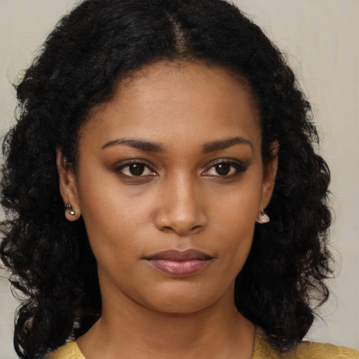 Neutral black young-adult female with long  brown hair and brown eyes