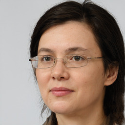 Joyful white adult female with long  brown hair and brown eyes