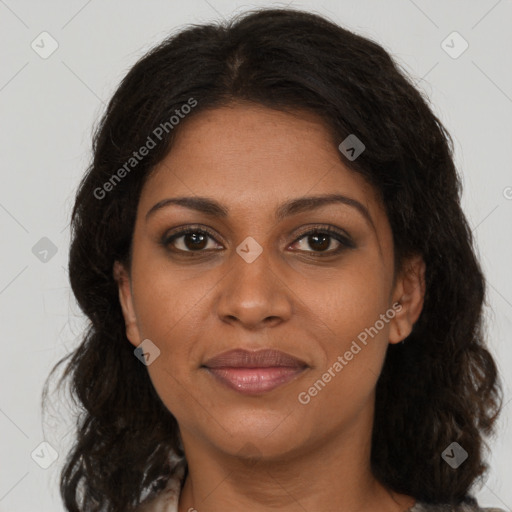 Joyful black young-adult female with long  brown hair and brown eyes