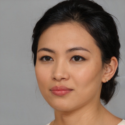 Joyful asian young-adult female with medium  brown hair and brown eyes