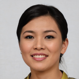 Joyful asian young-adult female with medium  brown hair and brown eyes